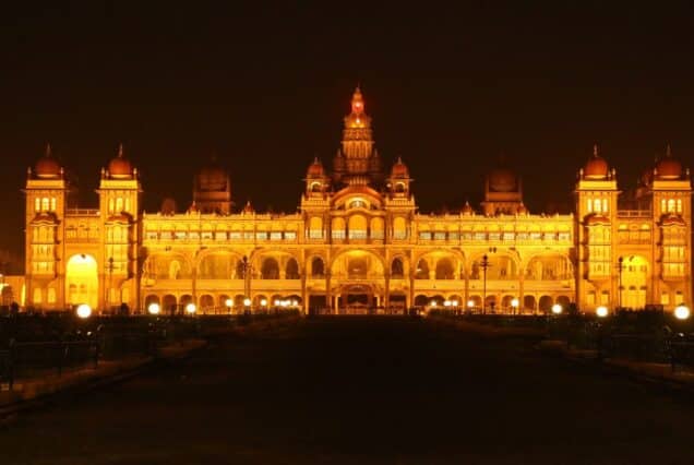 Mysore Palace glowing at night with golden lights in Mysuru, Karnataka.